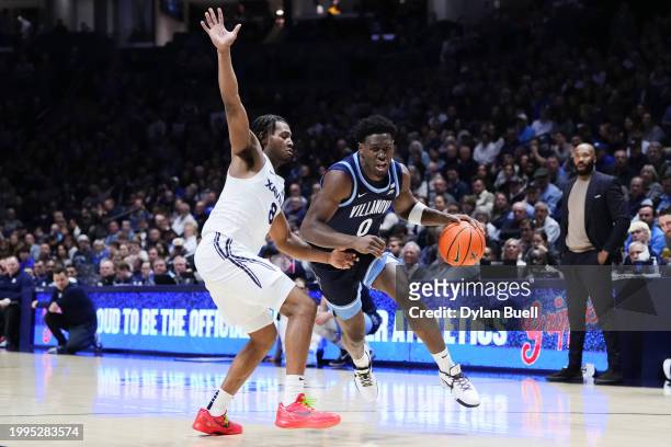 Bamba of the Villanova Wildcats dribbles the ball while being guarded by Quincy Olivari of the Xavier Musketeers in the second half at the Cintas...
