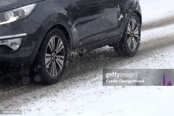 Car drives on a snow covered road on February 08, 2024 in Bradford, United Kingdom. The Met Office issued two amber warnings for snow and ice,...