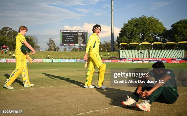 Callum Vidler and Rafael MacMillan of Australia celebrates as Mohammad Zeeshan of Pakistan cuts a dejected figure following the ICC U19 Men's Cricket...