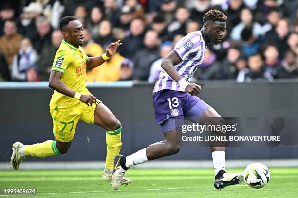 Nantes' Ivorian forward Benie Traore fights for the ball with Toulouse's French defender Christian Mawissa Elebi during the French L1 football match...