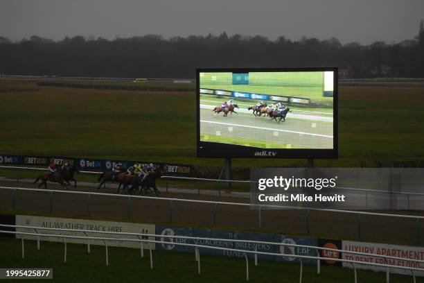 Runners and riders approach the finish line in appalling light during the sixth race, the BetMGM: It's Showtime Handicap, at Lingfield Park on...