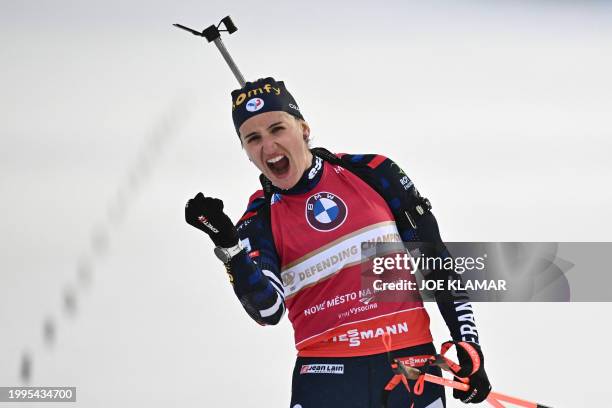 France's Julia Simon celebrates as she crosses the finish line to win the women's 10 km pursuit event of the IBU Biathlon World Championships in Nove...