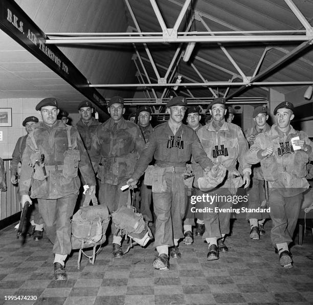 Soldiers of the 3rd Battalion Parachute Regiment carrying their kit at an airport en route to participating in Operation Musketeer during the Suez...