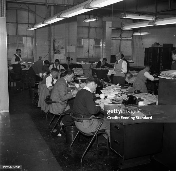 The sports desk editorial staff of the Evening Standard newspaper, Shoe Lane, London, May 7th 1957.