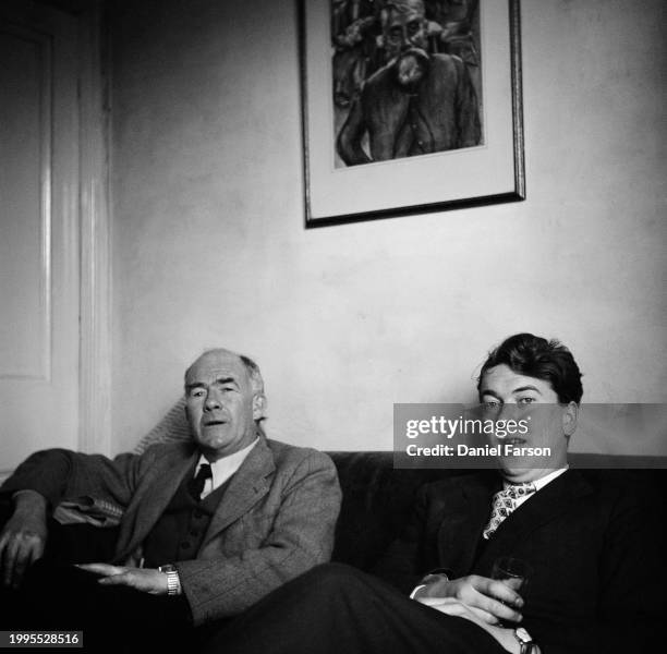 Writer Kingsley Amis at home with a friend at his house at 24 The Grove, Uplands, Swansea, June 18th 1956.