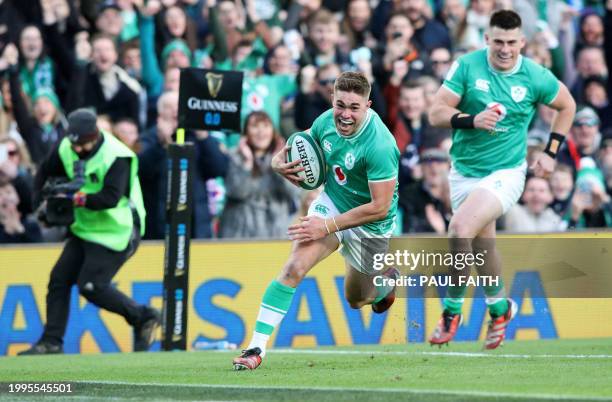 Ireland's fly-half Jack Crowley scores the team's first try during the Six Nations international rugby union match between Ireland and Italy at the...