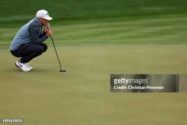 Alex Noren of Sweden lines up a putt on the eighth green during the first round of the WM Phoenix Open at TPC Scottsdale on February 08, 2024 in...