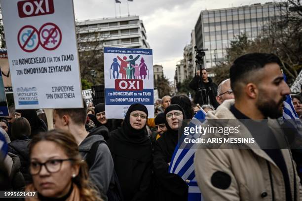 Protesters hold placards reading "No" during a demonstration against a reform legalising same-sex marriage and adoption, that will be debated by...