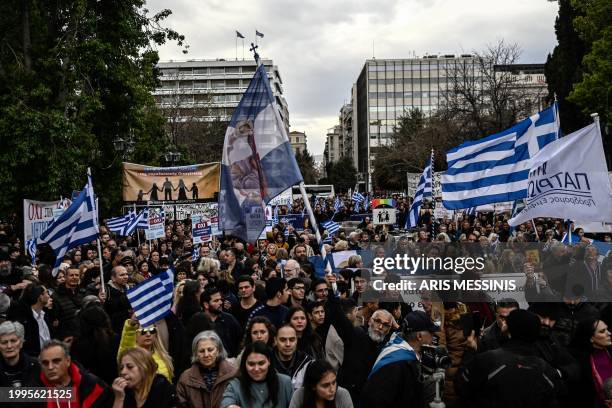 Protesters hold national flags during a demonstration against a reform legalising same-sex marriage and adoption, that will be debated by parliament...