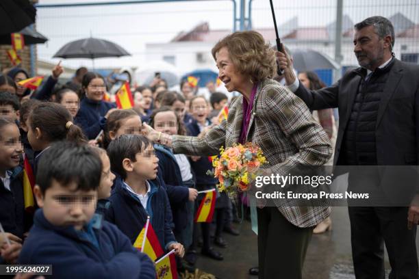 Queen Sofia greets children waiting for her before her visit to the Food Bank, February 8 in Huelva, . Queen Sofia visits the facilities of the Food...