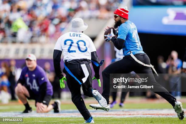 Keenan Allen of the Los Angeles Chargers and AFC runs with the ball after catching a pass during the 2024 NFL Pro Bowl at Camping World Stadium on...