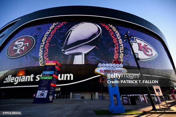 Welcome To Las Vegas Super Bowl LVIII sign stands at sunrise outside of Allegiant Stadium wrapped with the logos of the Kansas City Chiefs and San...