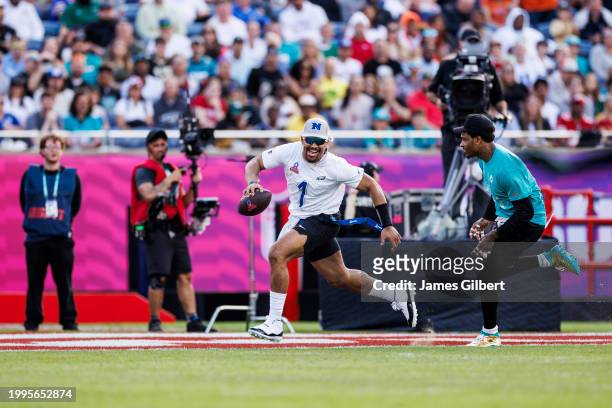 Jalen Hurts of the Philadelphia Eagles and NFC runs with the ball against Jalen Ramsey of the Miami Dolphins and AFC during the 2024 NFL Pro Bowl at...