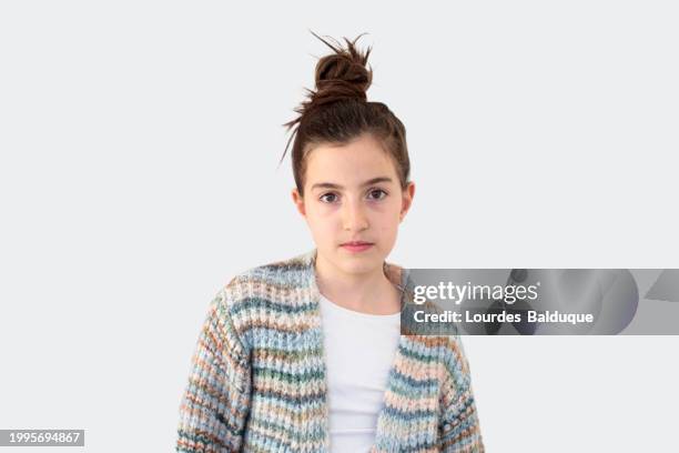 portrait of girl with serious gesture on white background - haarknoten stock-fotos und bilder