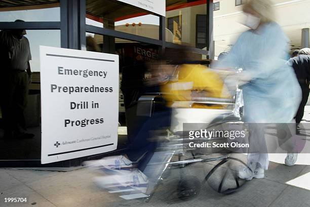 Mock patient is wheeled into the emergency room at Advocate Lutheran Hospital May 13, 2003 in Park Ridge, Illinois. Fifty biohazard patients were...
