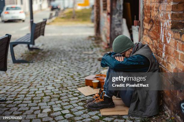 despair homeless man on the street - city life authentic stock pictures, royalty-free photos & images