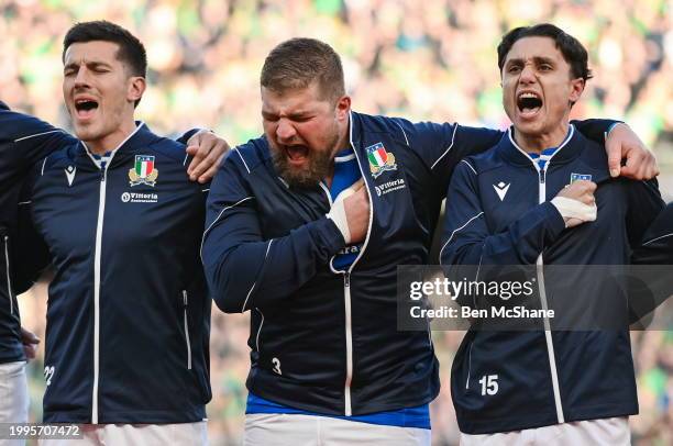 Dublin , Ireland - 11 February 2024; Italy players, from left, Tomasso Allan, Pietro Ceccarelli, and Ange Capuozzo sing their national anthem before...