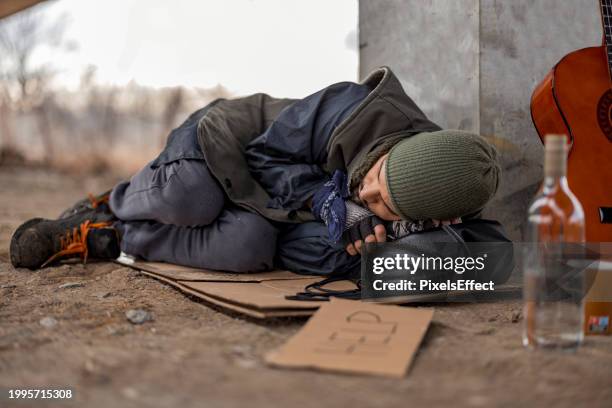 homeless man sleeping - homeless person stock pictures, royalty-free photos & images