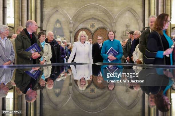 Queen Camilla takes a moment of reflection at The Salisbury font, designed by British water sculptor William Pye during a musical evening at...
