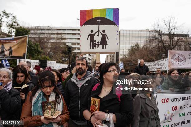 Protesters hold banners during a demonstration against the upcoming vote in parliament on the same-sex marriage bill, in Athens, Greece, on Sunday,...