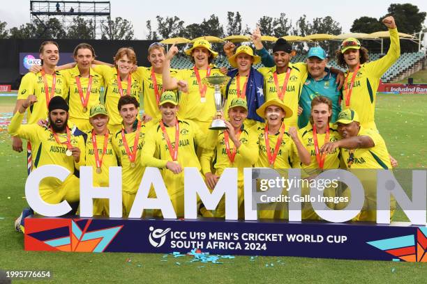 Hugh Weibgen, Captain of Australia, and Harry Dixon lift the ICC U19 Men’s Cricket World Cup trophy as players of Australia pose for a team...