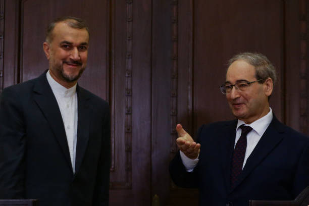 Syria's Foreign Minister Faisal Mekdad and his Iranian counterpart Hossein Amir-Abdollahian talk to reporters at the Foreign Ministry in Damascus on...