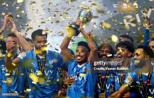 Salem Al-Dawsari of Al Hilal lifts the Riyadh Season Cup trophy as players of Al Hilal celebrate after defeating Al-Nassr during the Riyadh Season...