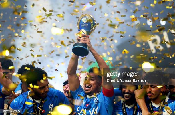 Salem Al-Dawsari of Al Hilal lifts the Riyadh Season Cup trophy as players of Al Hilal celebrate after defeating Al-Nassr during the Riyadh Season...