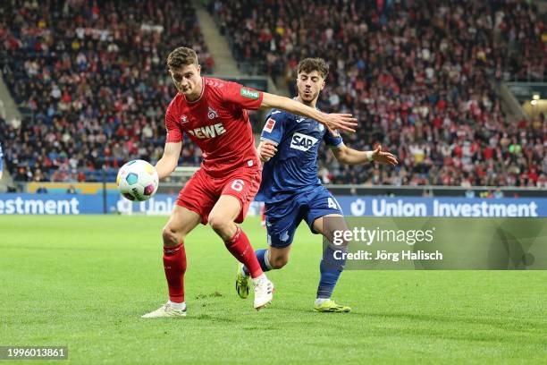 Eric Martel of Köln and Umut Tohumcu of Hoffenheim during the Bundesliga match between TSG Hoffenheim and 1. FC Köln at PreZero-Arena on February 11,...