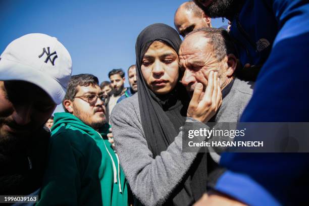 People mourn during the funeral of Lebanese civilian Hussein Hussein and policeman Ali Mahdi in Lebanon's southern town of Houla on February 11 who...