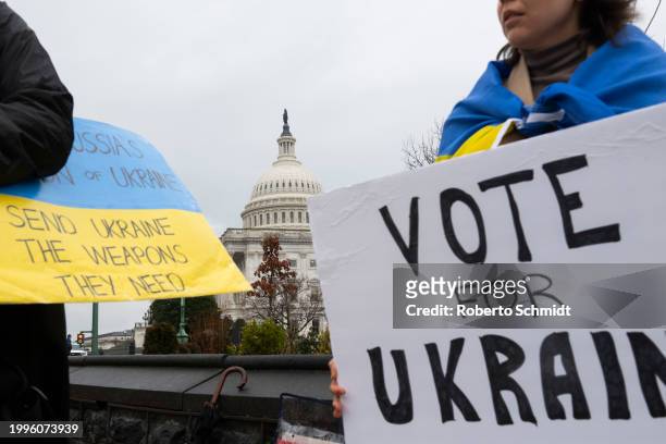 Ukraine sympathizers carry placards and fly a Ukrainian flag outside the U.S. Capitol building as the Senate works through the weekend on a $95.3...