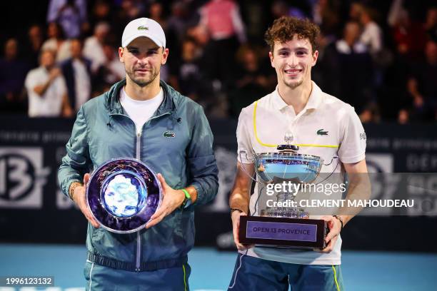 France's winner Ugo Humbert and Bulgaria's runner up Grigor Dimitrov pose with their trophies after the ATP Open 13 final tennis match on February...