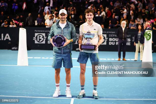 France's winner Ugo Humbert and Bulgaria's runner up Grigor Dimitrov pose with their trophies after the ATP Open 13 final tennis match on February...
