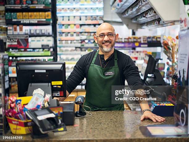 small business owner at work in his small convenience store - counter stock pictures, royalty-free photos & images