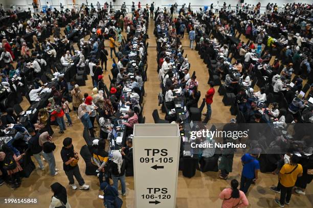 Indonesians living in Malaysia are registering before casting their ballots at a polling station for the early voting process for citizens living...