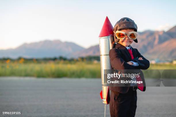 young boy businessman ready to fly - rocket booster stock pictures, royalty-free photos & images
