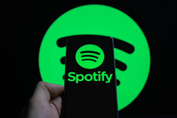 The Spotify logo is being displayed on a smartphone with the Spotify icon visible in the background in this photo illustration in Brussels, Belgium,...