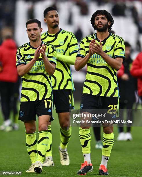 Cedric Soares and Mohamed Elneny of Arsenal FC applauds fans during the Premier League match between West Ham United and Arsenal FC at London Stadium...