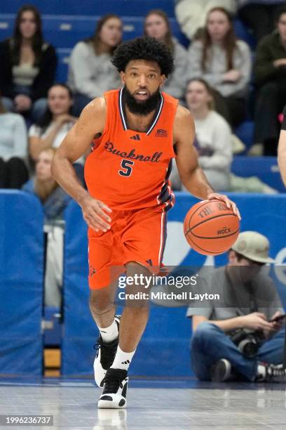 Elvin Edmonds IV of the Bucknell Bison dribbles down court during a college basketball game against the American University Eagles at Bender Arena on...