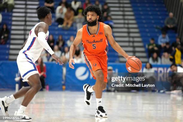 Elvin Edmonds IV of the Bucknell Bison dribbles the ball during a college basketball game against the American University Eagles at Bender Arena on...