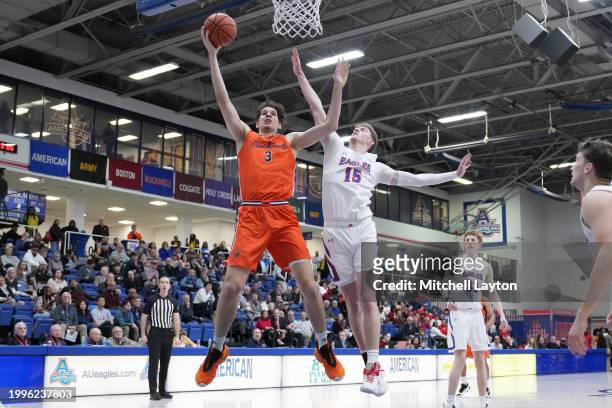 Noah Williamson of the Bucknell Bison takes a shot over Matt Rogers of the American University Eagles during a college basketball game at Bender...