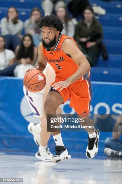 Elvin Edmonds IV of the Bucknell Bison dribbles down court during a college basketball game against the American University Eagles at Bender Arena on...