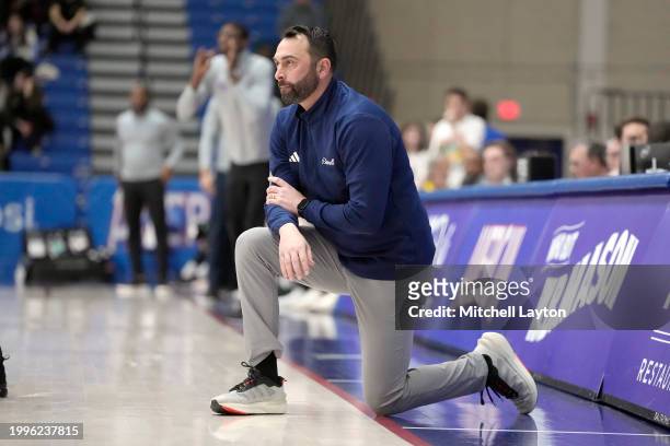 Head coach John Griffin III of the Bucknell Bison looks on during a college basketball game against the American University Eagles at Bender Arena on...