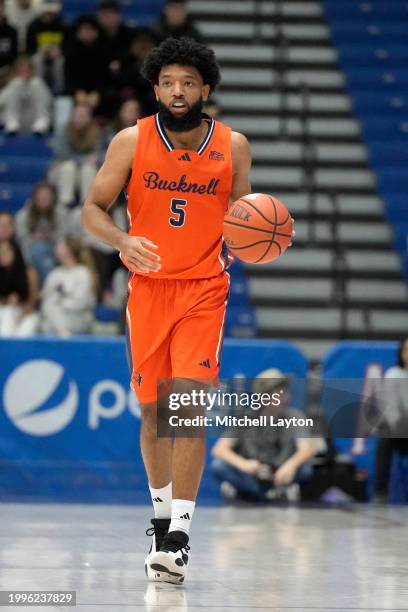Elvin Edmonds IV of the Bucknell Bison dribbles down court during a college basketball game against the American University Eagles at Bender Arena on...