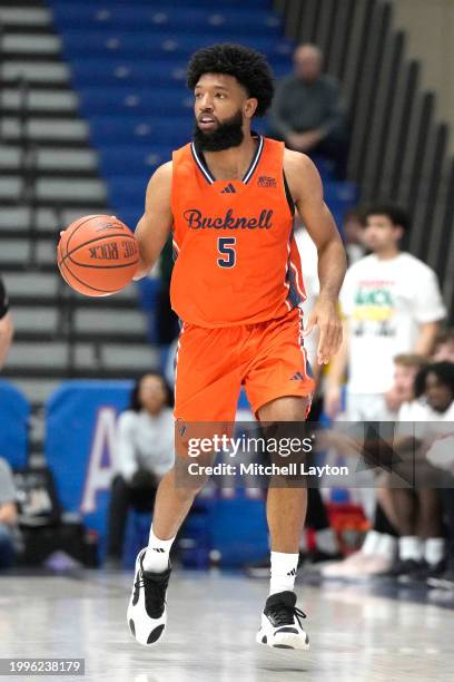 Elvin Edmonds IV of the Bucknell Bison dribbles down court during a college basketball game against the American University Eagles at Bender Arena on...