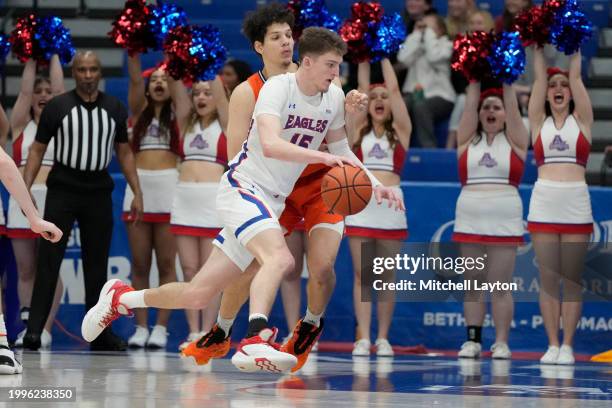 Matt Rogers of the American University Eagles dribbles by Noah Williamson of the Bucknell Bison during a college basketball game at Bender Arena on...