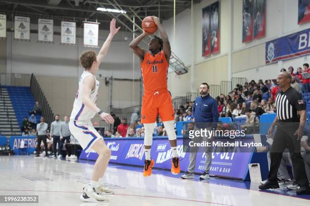 Josh Adoh of the Bucknell Bison takes a shot over Matt Mayock of the American University Eagles n during a college basketball game at Bender Arena on...