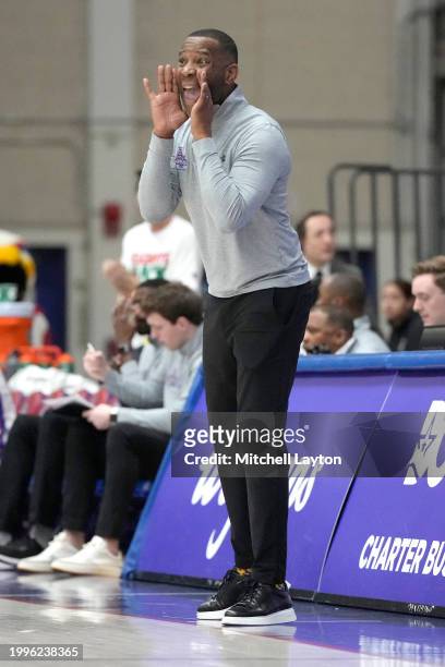 Head coach Duane Simpkins of the American University Eagles l yells to his players during a college basketball game against the Bucknell Bison at...