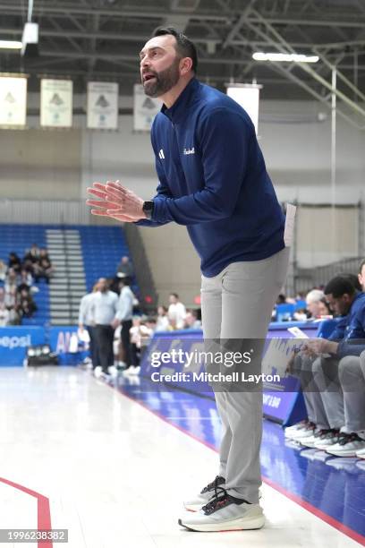 Head coach John Griffin III of the Bucknell Bison signals to his players during a college basketball game against the American University Eagles at...