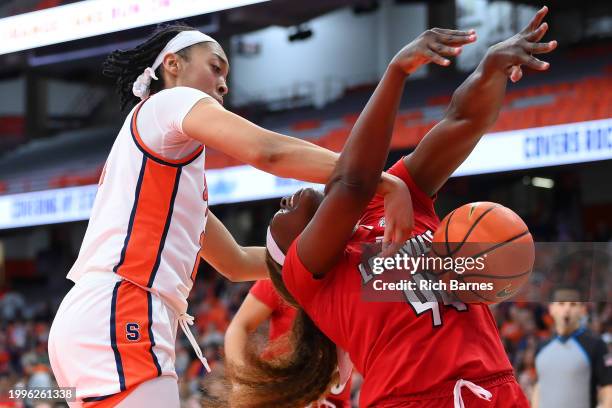 Saniaa Wilson of the Syracuse Orange and Olivia Cochran of the Louisville Cardinals battle for the ball during the first half at JMA Wireless Dome on...